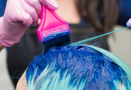 Hairdresser applying blue paint to female with eme 2025 02 12 03 33 31 utc 1